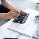 A person stressed over unpaid rent and bills looking for an emergency loan with bad credit.
