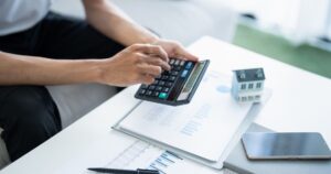 A person stressed over unpaid rent and bills looking for an emergency loan with bad credit.