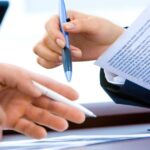 A person reviewing a short term signature loan offer for bad credit on a laptop at home.
