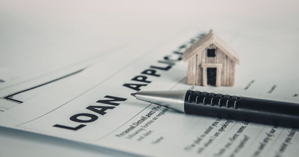 A person reviewing a short term signature loan application for bad credit on a laptop at home.