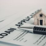 A person reviewing a short term signature loan application for bad credit on a laptop at home.